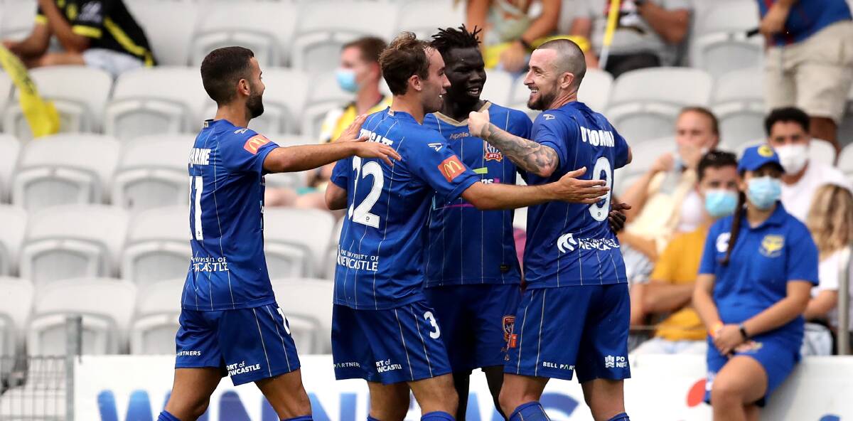 ON TARGET: Jets players celebrate with Roy O'Donovan after the striker scored the second goal in a 2-1 win over Wellington in Wollongong on Sunday. Picture: Getty Images