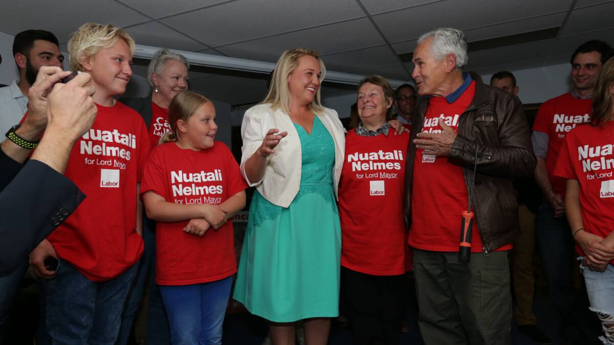 Re-elected Labor Lord Mayor Nuatali Nelmes addresses her supporters at Lambton Bowling Club. Pictured left to right with her son Archie, 15, daughter Ruby-Lou, 10, and Suska and Paul Scobie. PICTURE: Simone De Peak