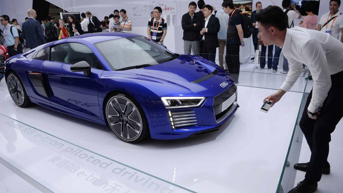 The future ... of Newcastle? Visitors look at the Audi R8 e-tron, a driverless electronic car, as it is displayed at the inaugural International Consumer Electronics Show (CES) Asia in Shanghai in May. PICTURE: AP