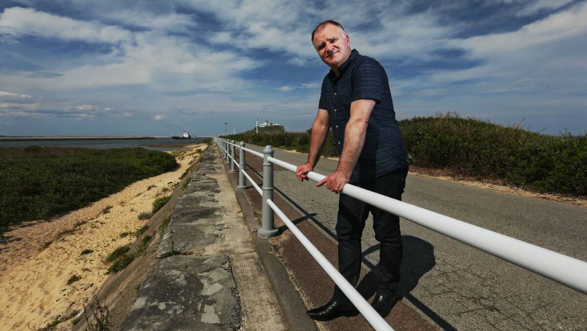 RICH HISTORY: Historian Gionni Di Gravio on the convict-built Macquarie Pier which now extends along the breakwall to Nobbys headland. Picture: Simone De Peak