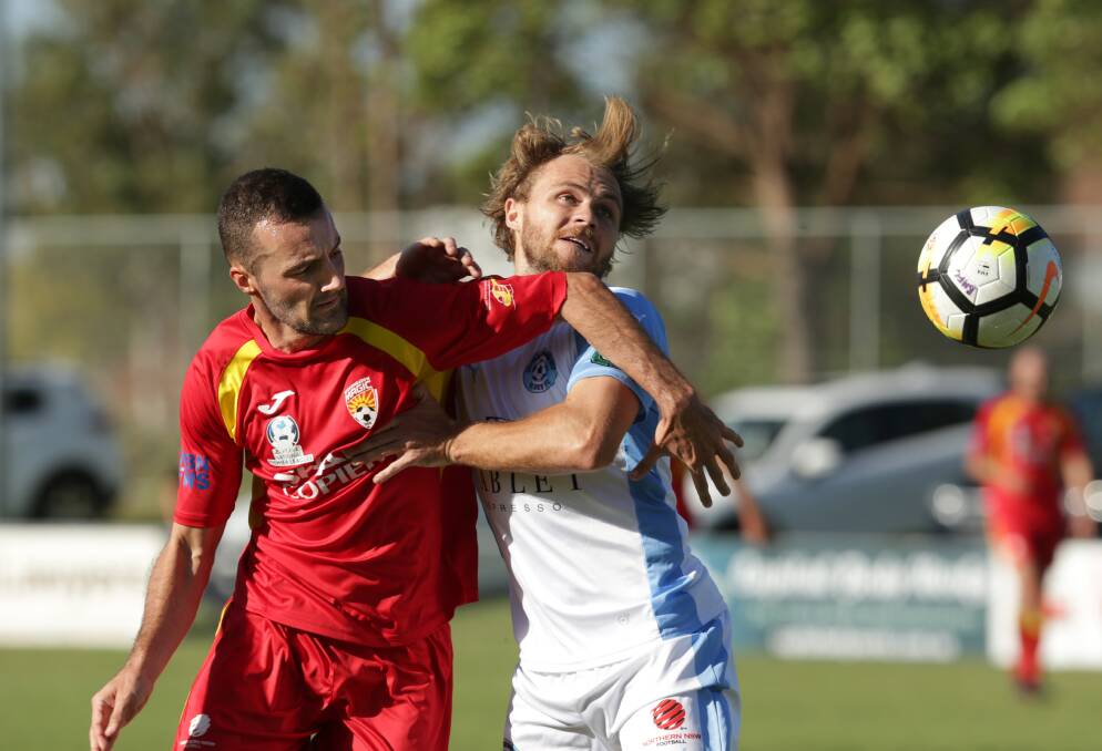 NEW DIRECTION: Broadmeadow winger James Virgili and now former Charlestown defender Tom Smart battle it out. The pair will be key players at Magic this season for new coach Anthony Richards. Picture: Simone De Peak