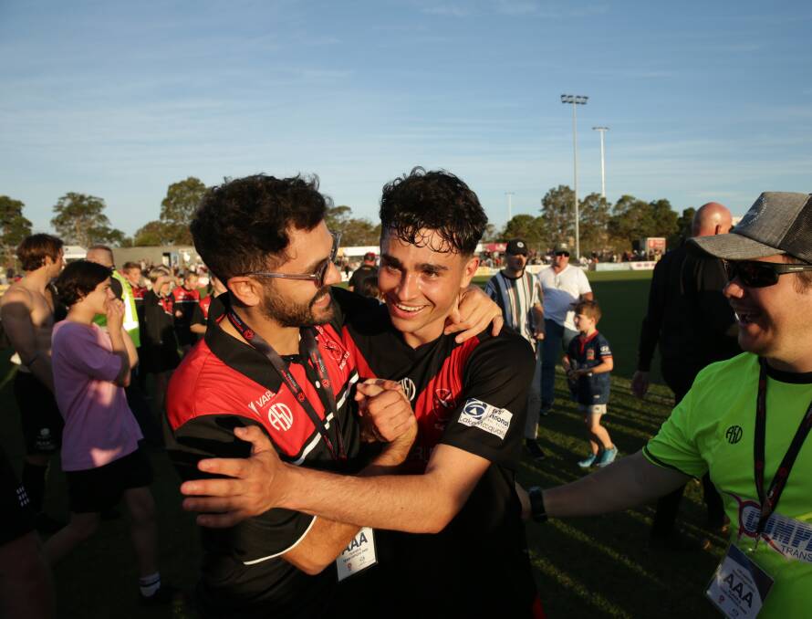 STAR: Daniel Fabrizio, right, is congratulated by injured Eagle Dom Bizzarri after the grand final on Sunday. Picture: Max Mason-Hubers