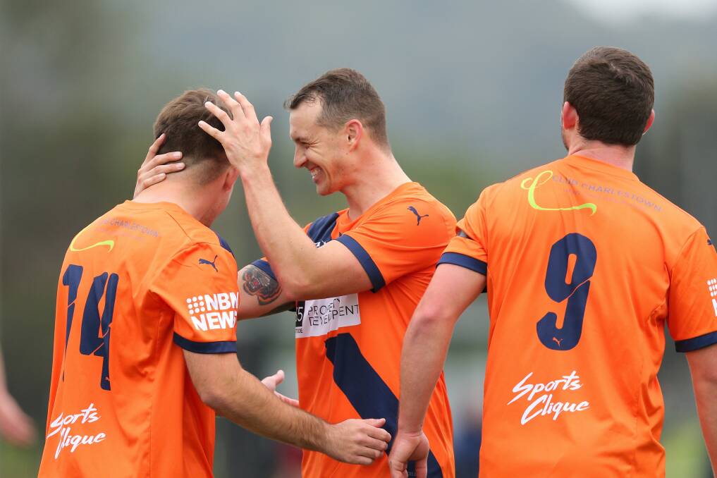 BIG WIN: Valentine man of the match Matt Paul, centre, celebrates a goal against Kahibah on Saturday. Picture: Max Mason-Hubers