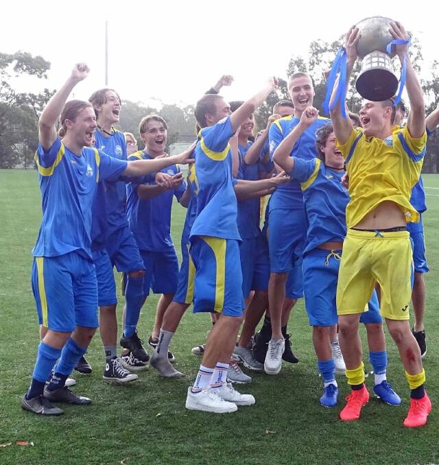 CHAMPIONS: Hunter captain Jack Kenny lifts the trophy as his squad celebrate their victory over Sydney North on penalties in the final. Picture: NSW Combined High Schools Sports Association