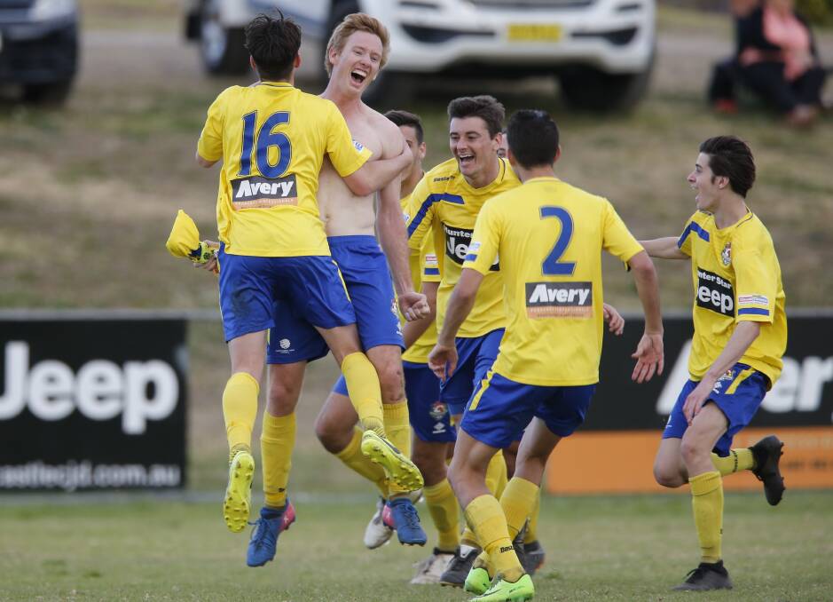 NICE FINISH: Lake Macquarie celebrate with Sam Walker after his last-round match-winner. Picture: Sproule Sports Focus