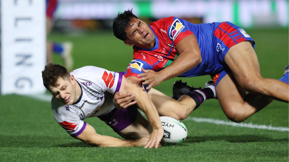 CLOSE: Storm halfback Ryley Jacks beats Herman Ese'ese to the ball to score on Saturday night. Picture: NRL Imagery