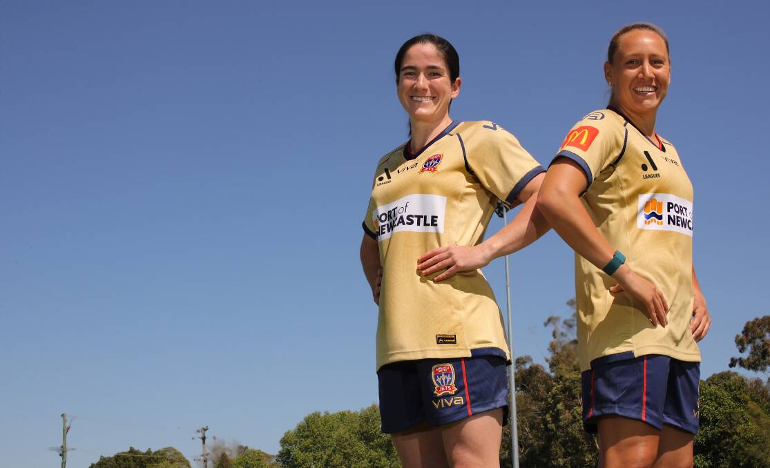 SUPPORT: Jets women's players Lauren Allan and Gema Simon in their new gold playing strips. Picture: Supplied