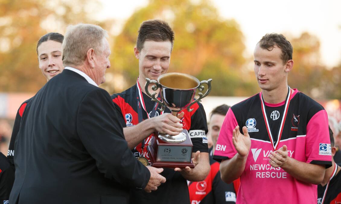 Josh Evans with the grand final winners trophy. Picture: Max Mason-Hubers