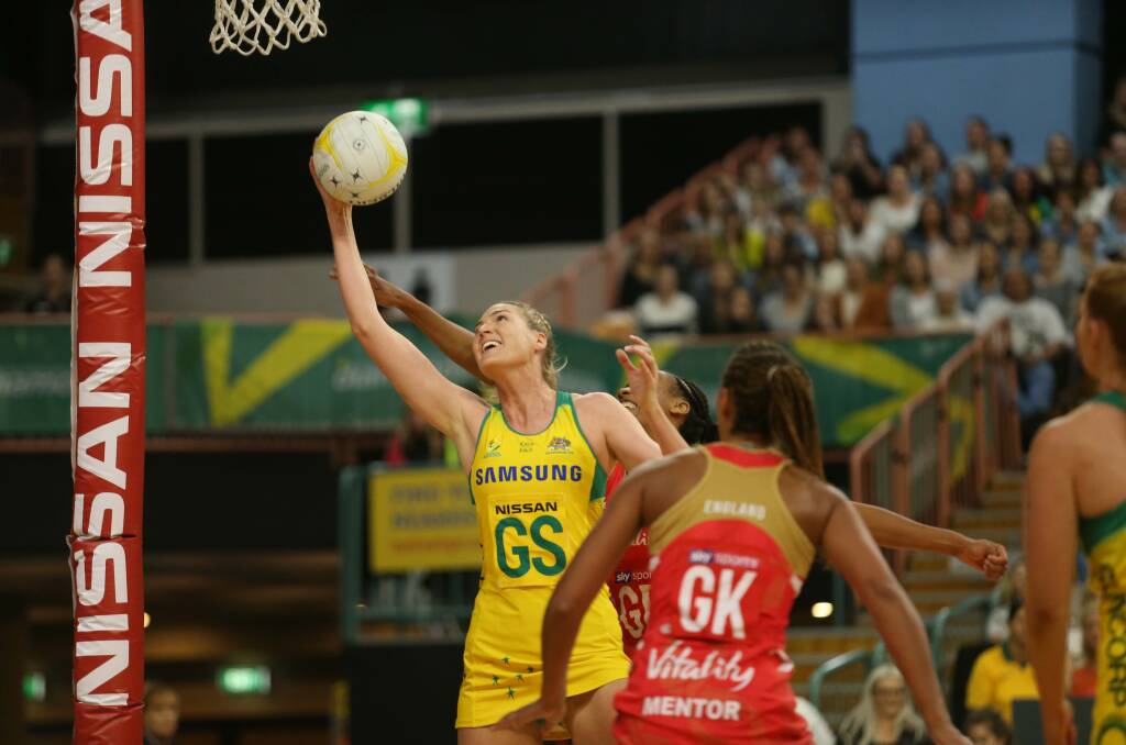 UP AND AWAY: Australian goal shooter and captain Caitlin Bassett battles for possession on Wednesday night in the Test match against England at Newcastle Entertainment Centre. Picture: Marina Neil