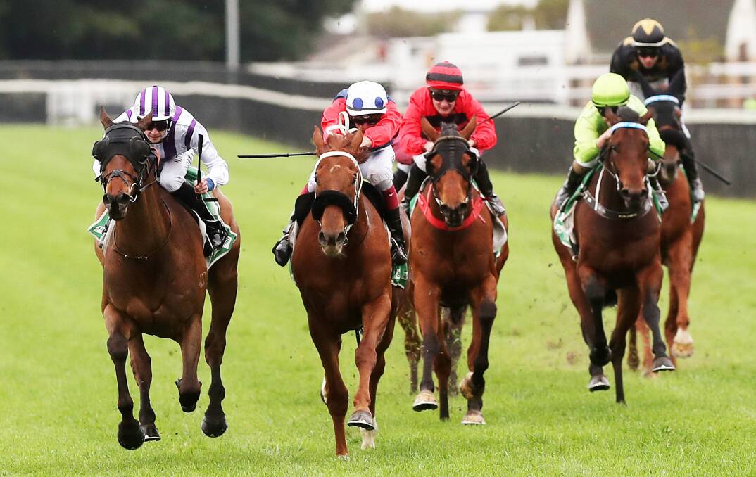 CLOSE: Dylan Gibbons and Dragon Dream, left, hold off all challengers to win the fourth race at Newcastle on Thursday. Picture: Peter Lorimer