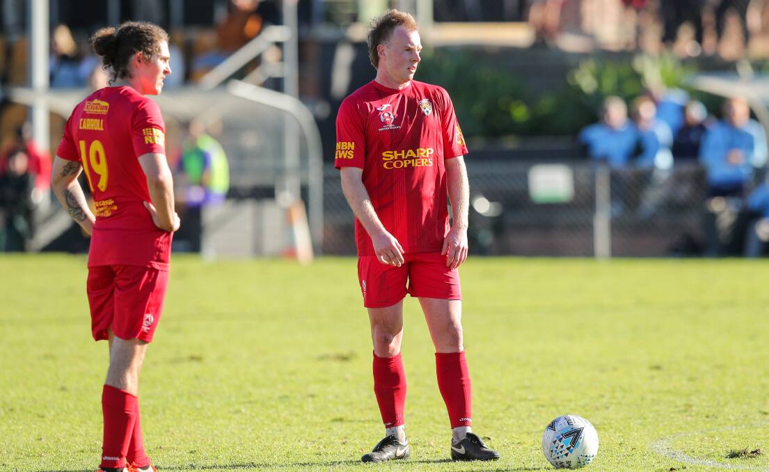 EYES ON THE PRIZE: Broadmeadow's Mitch Rooke, right, lines up a free kick against Charlestown Azzurri on Sunday at Magic Park in their 3-1 win. Picture: Max Mason-Hubers