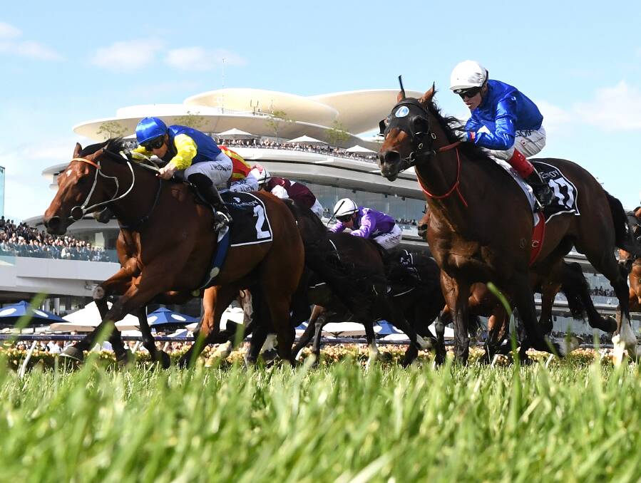 TOUGH: Le Romain, left, battles it out with eventual winner Best Of Days, right, in the group 1 Kennedy Mile at Flemington on Saturday. Picture: AAP 