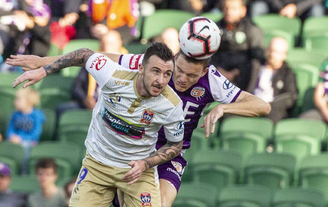 UNKNOWN: Off-contract Jets striker Roy O'Donovan contests a header in the 1-0 loss to Perth Glory on Sunday. Picture: AAP