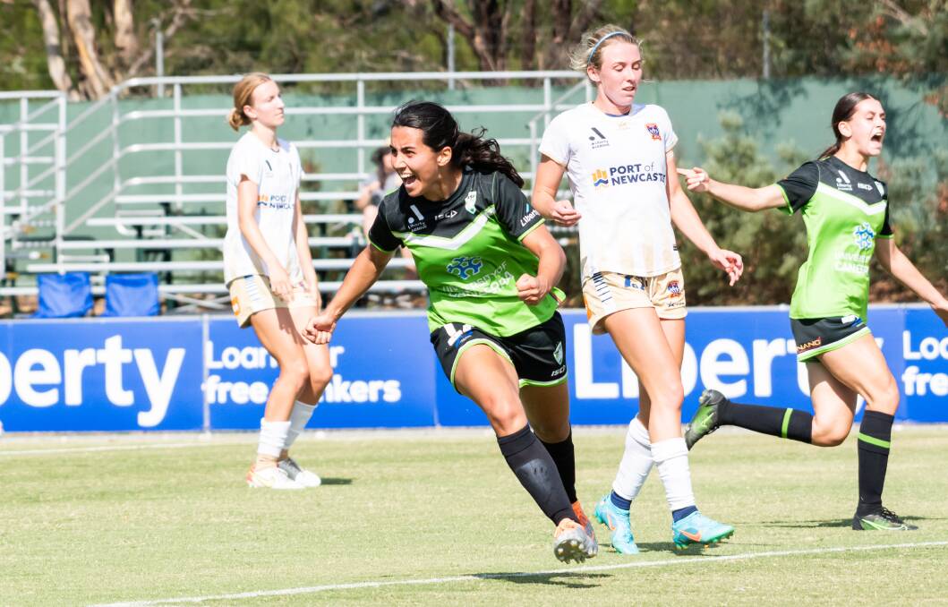 Canberra United's Vesna Milivojevic celebrates a goal on Saturday against a dejected Newcastle defence at McKellar Park. Picture by Elesa Kurtz