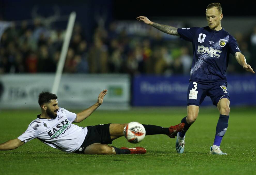 Nick Cowburn slides in for a tackle against the Central Coast Mariners in Maitland's round of 32 FFA Cup clash on July 31 at Maitland Sportsground. Picture: AAP