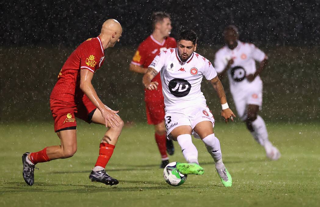 TOUGH TASK: Broadmeadow's Aaron Oppedisano tries to stop Wanderers star Dimi Petratos on Wednesday night. Picture: Getty Images