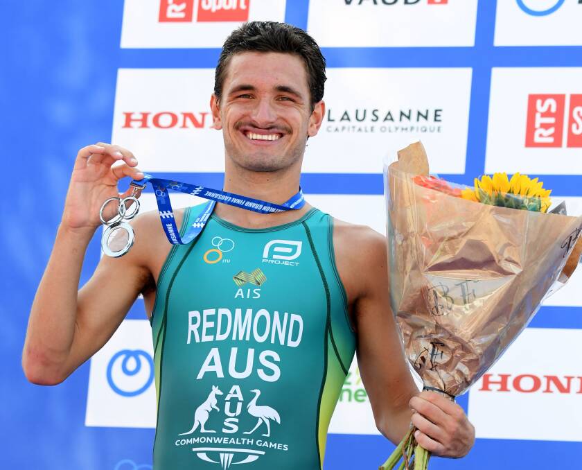 THRILLED: Newcastle's Lorcan Redmond on the podium in Lausanne after finishing second in the world junior triathlon titles. Picture: Delly Carr/Triathlon Australia