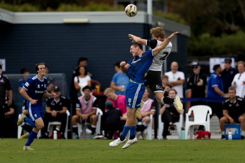 Olympic's Archie Finn, left, and Maitland's Callum Bower contest a header on Saturday. Picture by Jonathan Carroll