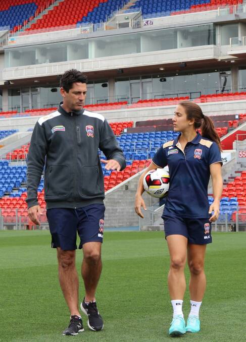 HIRED GUN: Jets W-League coach Craig Deans with Jen Hoy on Friday at McDonald Jones Stadium, where Newcastle play all but one of their home games. Picture: NNSWF