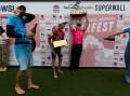 Surfest winners Joel Vaughan and Ellie Harrison, centre, get a champagne shower. Pictures by Jonathan Carroll