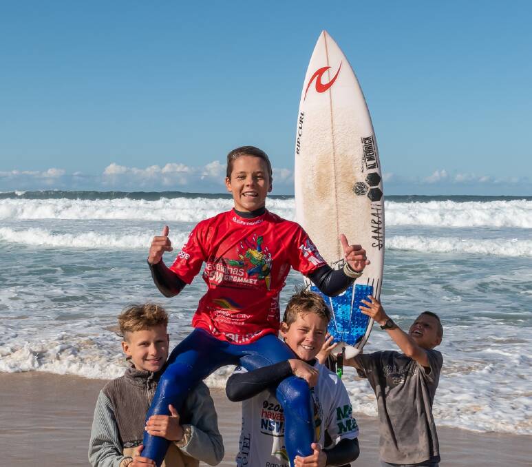 WILD RIDE: Merewether's Ocean Lancaster is chaired up the beach after his victory on Monday in the under-14 NSW Grommet final at Maroubra.