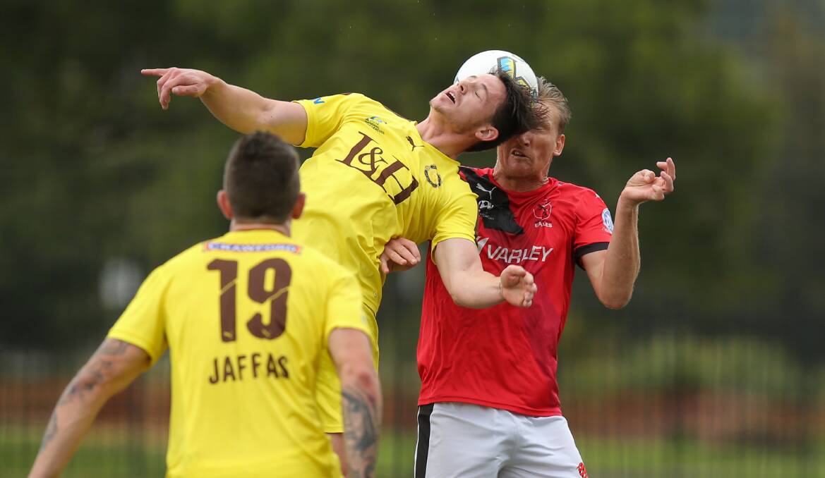 Jaffas' Liam O'Dell and Edgeworth's Daniel McBreen compete in the FFA Cup at Speers Point in 2017. Picture: Max Mason-Hubers