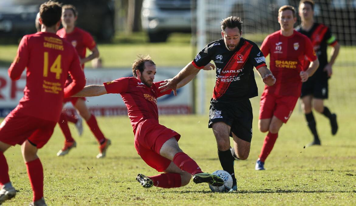 DEBUT WIN: New Edgeworth interim coach Josh Rose is tackled by Broadmeadow's Alex Kantarovski on Sunday at Magic Park in the Eagles' 1-0 victory. Picture: Marina Neil