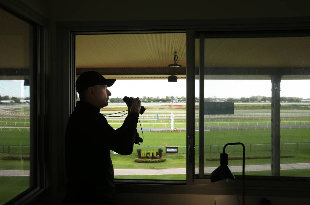 Kris Lees watches his team work at Newcastle Racecourse on Tuesday. Picture by Simone De Peak