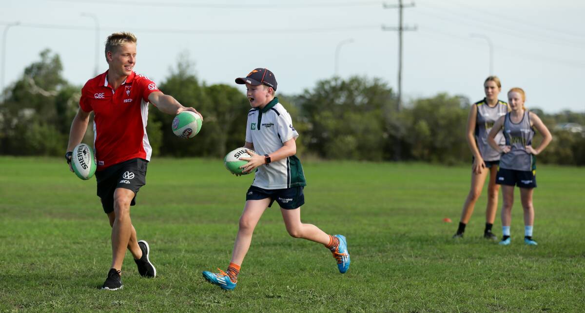 HELPING HAND: Swans star Isaac Heeney at a Hunter Academy of Sport session on Tuesday at Tulkaba Park, Teralba. Picture: Jonathan Carroll
