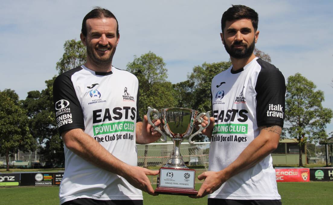 COUSINS: Maitland captain Carl Thornton and Nick Cowburn with the grand final trophy. Picture: NNSWF
