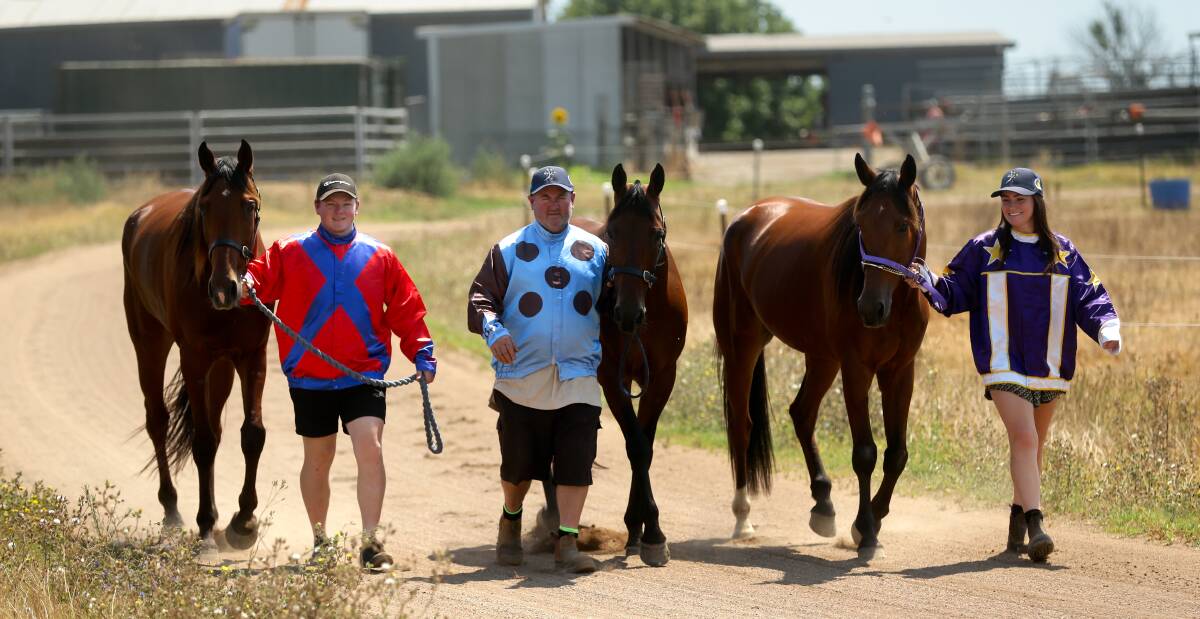 FAMILY AFFAIR: Driver Brad Elder with Our Uncle Alan, trainer Darren Elder with First Fleeter and trainer Melanie Elder with Ashark on Friday at their Louth Park property. Picture: Jonathan Carroll 