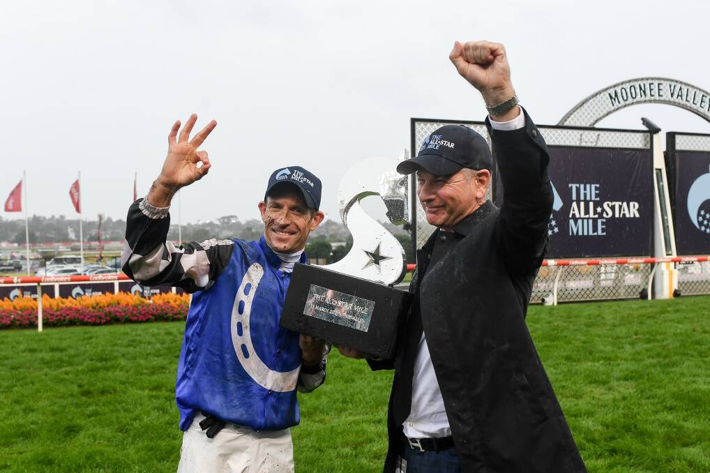 BIG PRIZE: Hugh Bowman and Kris Lees with the spoils. Picture: Racing Photos