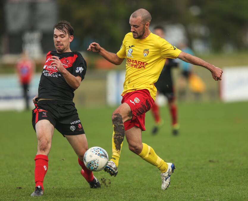 MARKED MAN: Broadmeadow Magic and former Newcastle Jets flyer James Virgili, right, takes on Edgeworth Eagles defender Pat Wheeler this season. Picture: Marina Neil