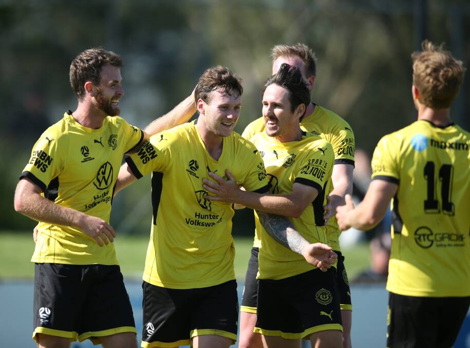 Lambton Jaffas players celebrate the opening goal of Ben Hay (second from left) in the NPL men's preliminary final against Broadmeadow at Magic Park on Sunday. Picture by Marina Neil