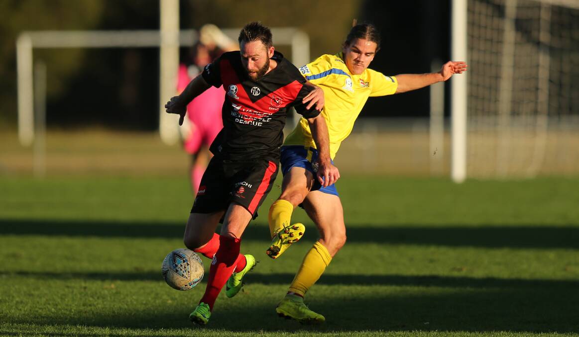 IN FRONT: Edgeworth star Josh Rose holds off Lake Macquarie's Isaac Robinson on Sunday at Jack McLaughlan Oval in their 3-0 victory. Picture: Max Mason-Hubers