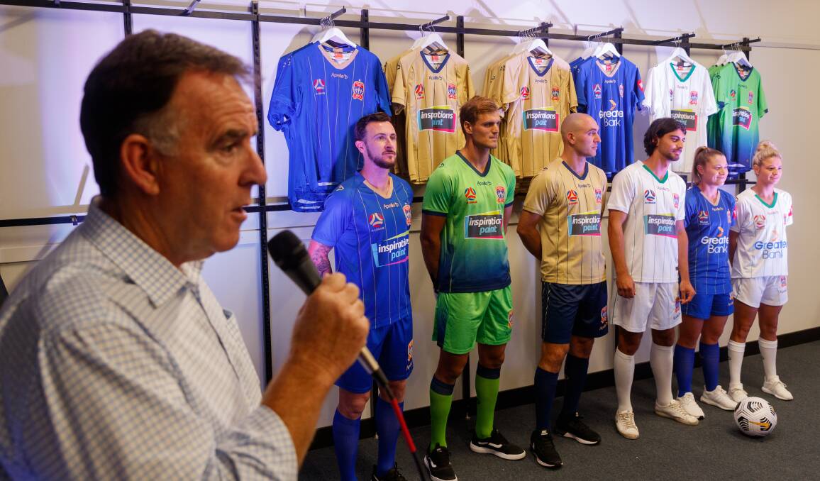 SHARP: Jets chief Lawrie McKinna unveils the playing strips on Tuesday at the club's merchandise store on King Street. Picture: Max Mason-Hubers