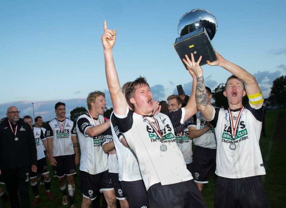 Strikers James Thompson and Braedyn Crowley hold aloft the NPL men's Northern NSW premiership trophy on Sunday after the Magpies' 3-1 win in the last round over Lambton Jaffas at Edden Oval. Picture by Jonathan Carroll.