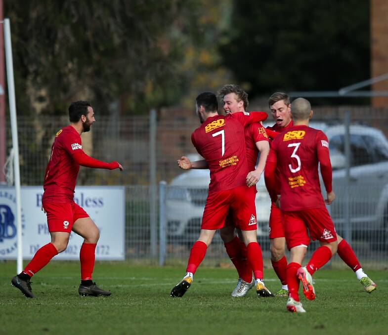EARLY JOY: Broadmeadow celebrate Damon Green's goal in the second minute of the 1-1 draw with Newcastle Olympic on Sunday at Darling Street Oval. Picture: Marina Neil