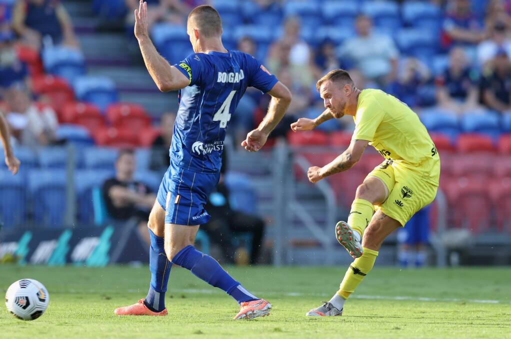 LUCKY: Wellington's David Ball scores the opening goal off the legs of Nigel Boogaard. Picture: Getty Images