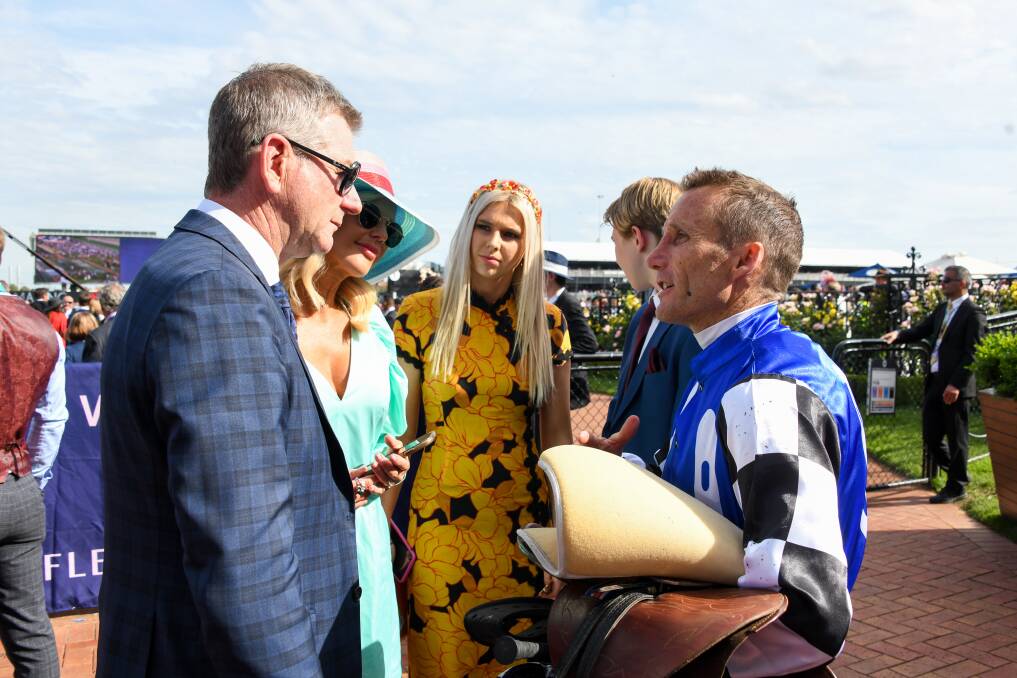 VICTORY: Newcastle trainer Kris Lees and his family talk with jockey Damien Oliver after Tactical Advantage's win on Tuesday. Picture: Getty Images