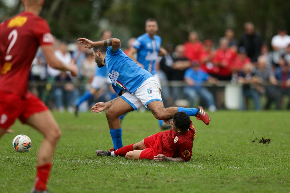 HEAVY: The mud flies as Azzurri's Dom Bizzarri and Magic's Keanu Moore tangle on Sunday at Lisle Carr Oval. Picture: Jonathan Carroll