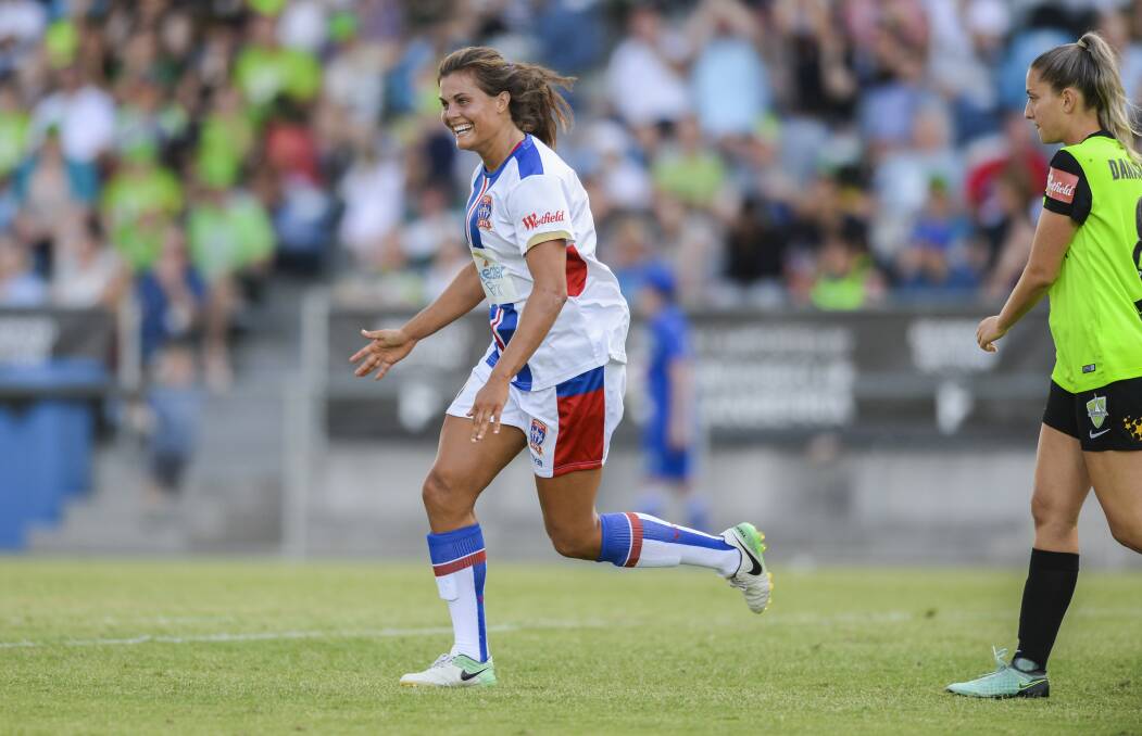 FLYING: Newcastle Jets striker Katie Stengel celebrates one of her three goals on Sunday against Canberra United at McKellar Park. Stengel moved to 10 goals for the season, just one behind golden boot leader Sam Kerr. Picture: AAP Image/Rohan Johnson