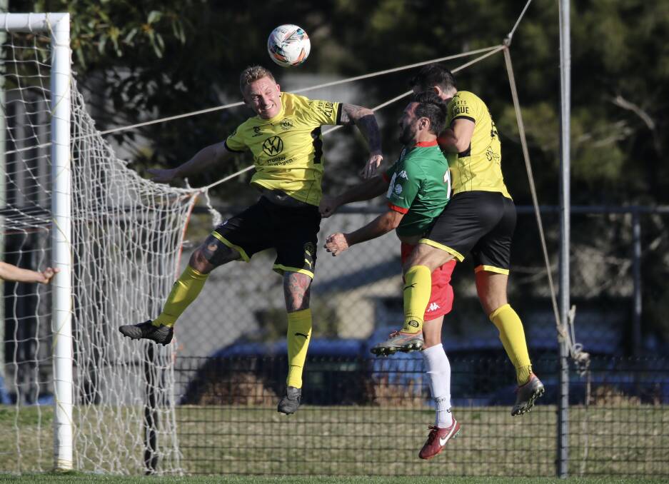 UP AND AWAY: Lambton Jaffas defender Josh Piddington rises for a header against Adamstown. He returned on Sunday from less than six weeks out with facial fractures. Picture: Sproule Sports Focus