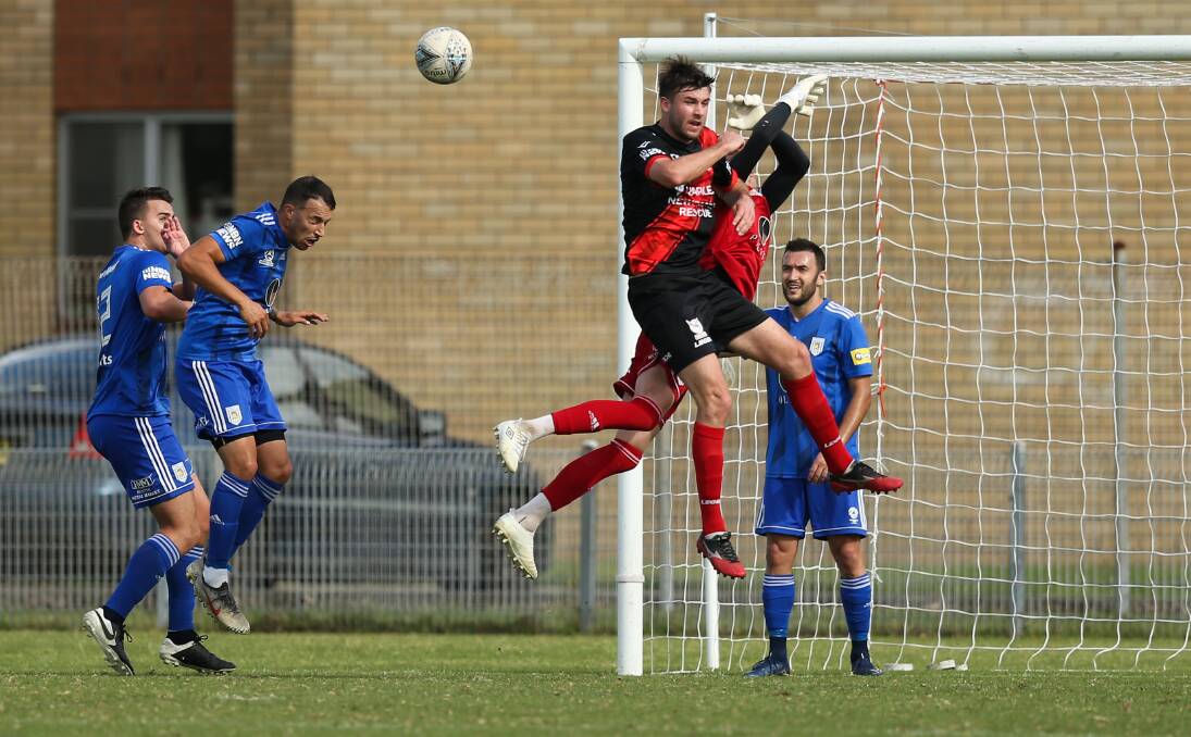 FLYING HIGH: Edgeworth defender Ayden Brice, centre, climbs for a header against Newcastle Olympic on Sunday at Darling Street Oval in their round 11 Northern NSW NPL game. Picture: Marina Neil