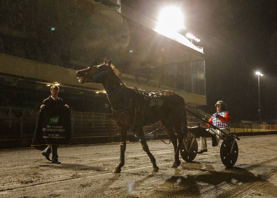 THROUGH: Newcastle Harness Racing Club boss Wayne Smith makes the presentation to Hunter Regional Championships heat winner Que Sera and driver Guy Chapple on Friday night. Picture: Max Mason-Hubers