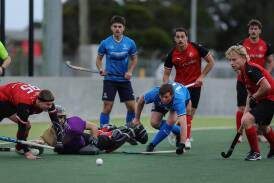 Norths' Jordan Willott, centre, in a scramble for possession in Sunday's 5-2 win over Souths. Picture by Marina Neil