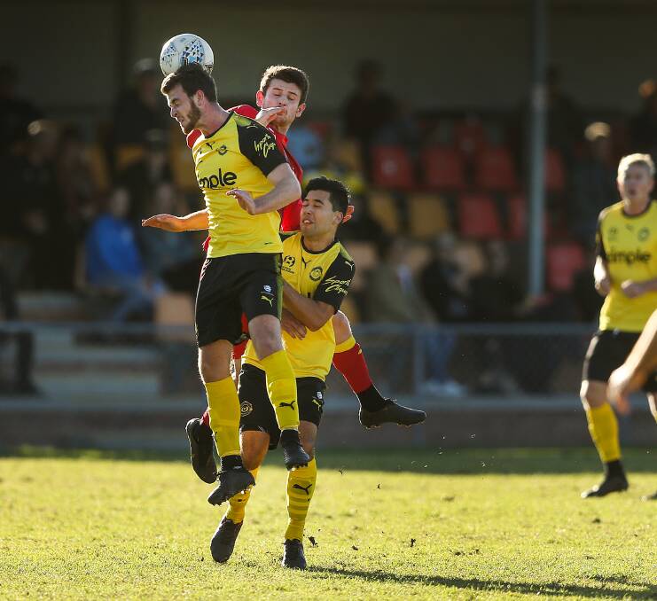 COMING TOGETHER: Mitch Oxborrow contests a header with Jaffas Tom Waller and Andrew Pawiak while playing for Broadmeadow this year. Picture: Marina Neil