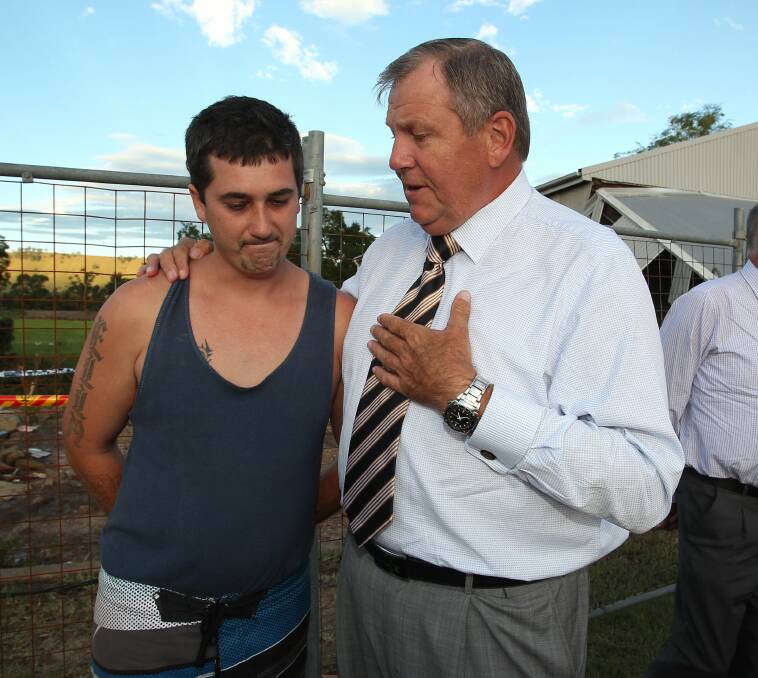 GRASSROOTS: Baldwin consoles a member of the Dungog community after last year's super storm. 