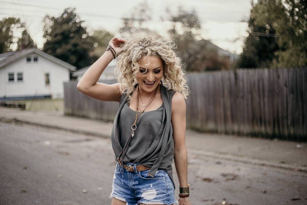 HAPPY: After several tough years former Newcastle musician and Gunnedah product Katrina Burgoyne is right at home in Nashville.