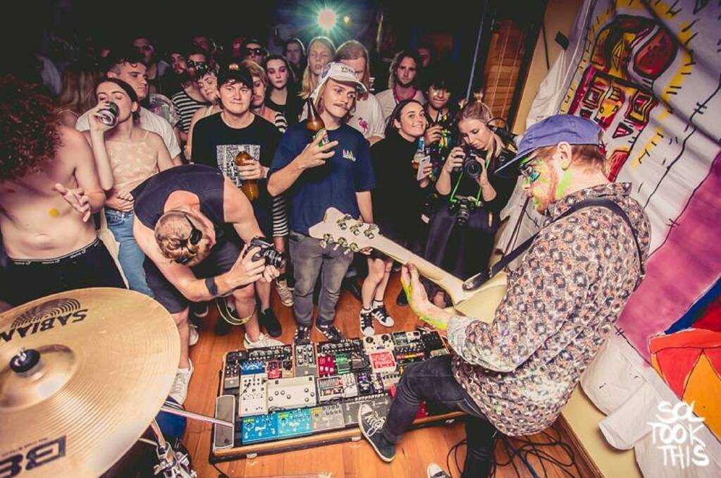 WILD: RAAVE TAPES frontman Joab Eastley testing out his 42 guitar pedals at a Merewether house party. Picture: Solomon Wilks